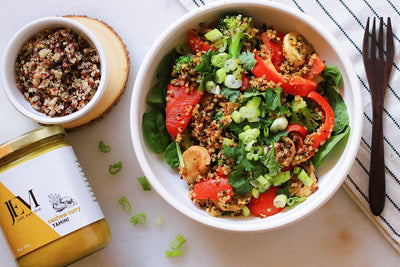 Curry Quinoa Stir Fry Salad next to a JEM Organics Cashew Curry Tahini jar