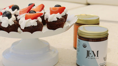 Small brownies topped with fresh blueberries and strawberries