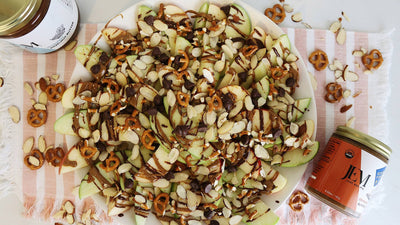 apple slices topped with nut butter and pretzels