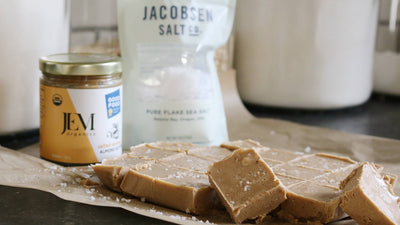 Cubed fudge next to a jar of JEM Organics Nut Butter and a Jacobsen Salt bag