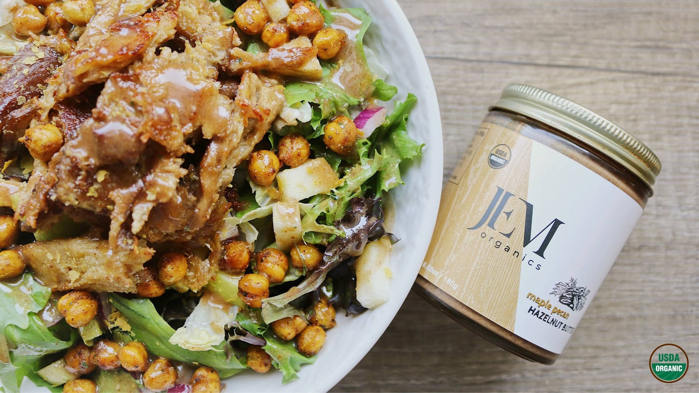 Salad topped with chickpeas, seitan and maple pecan dressing