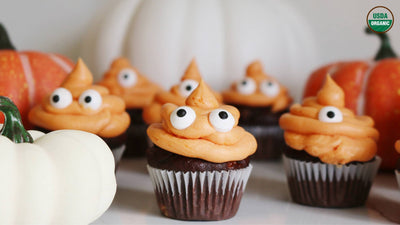 Chocolate cupcakes with orange frosting and googly eyes