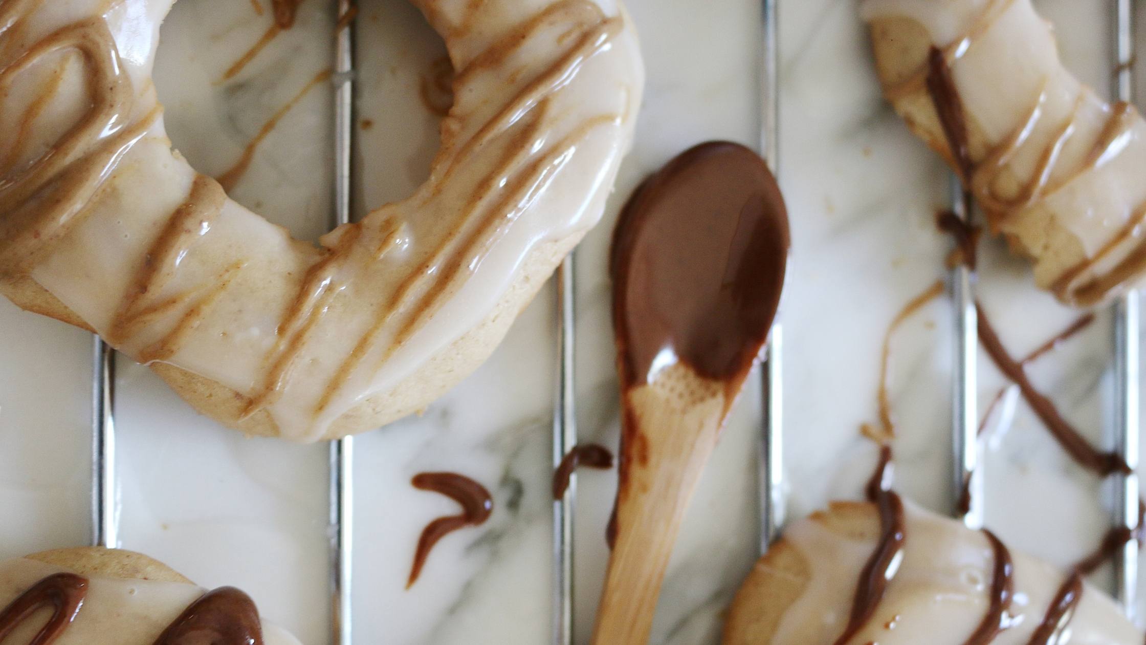 Homemade donuts with glaze and drizzled with nut butter