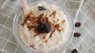 Rice pudding in glass bowl with a wooden spoon